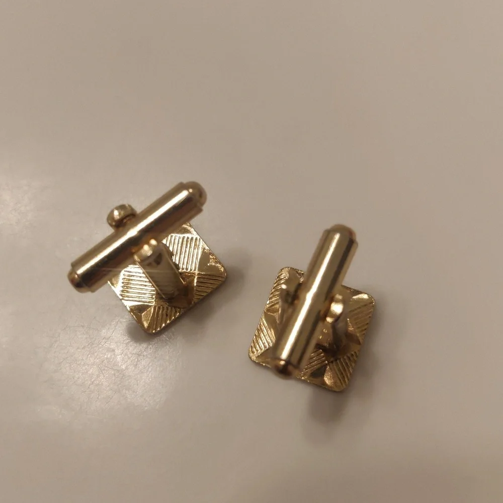 vintage gold-tone cufflinks featuring a distinct geometric, criss-cross